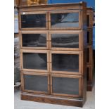 A Minty four tier sectional oak Bookcase enclosed by clear glass doors on a plinth base. 2' 11" (
