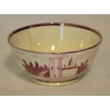 A 19th century pink lustre Bowl decorated with a church, 6" (15cms) diameter, and a lustre Cup and