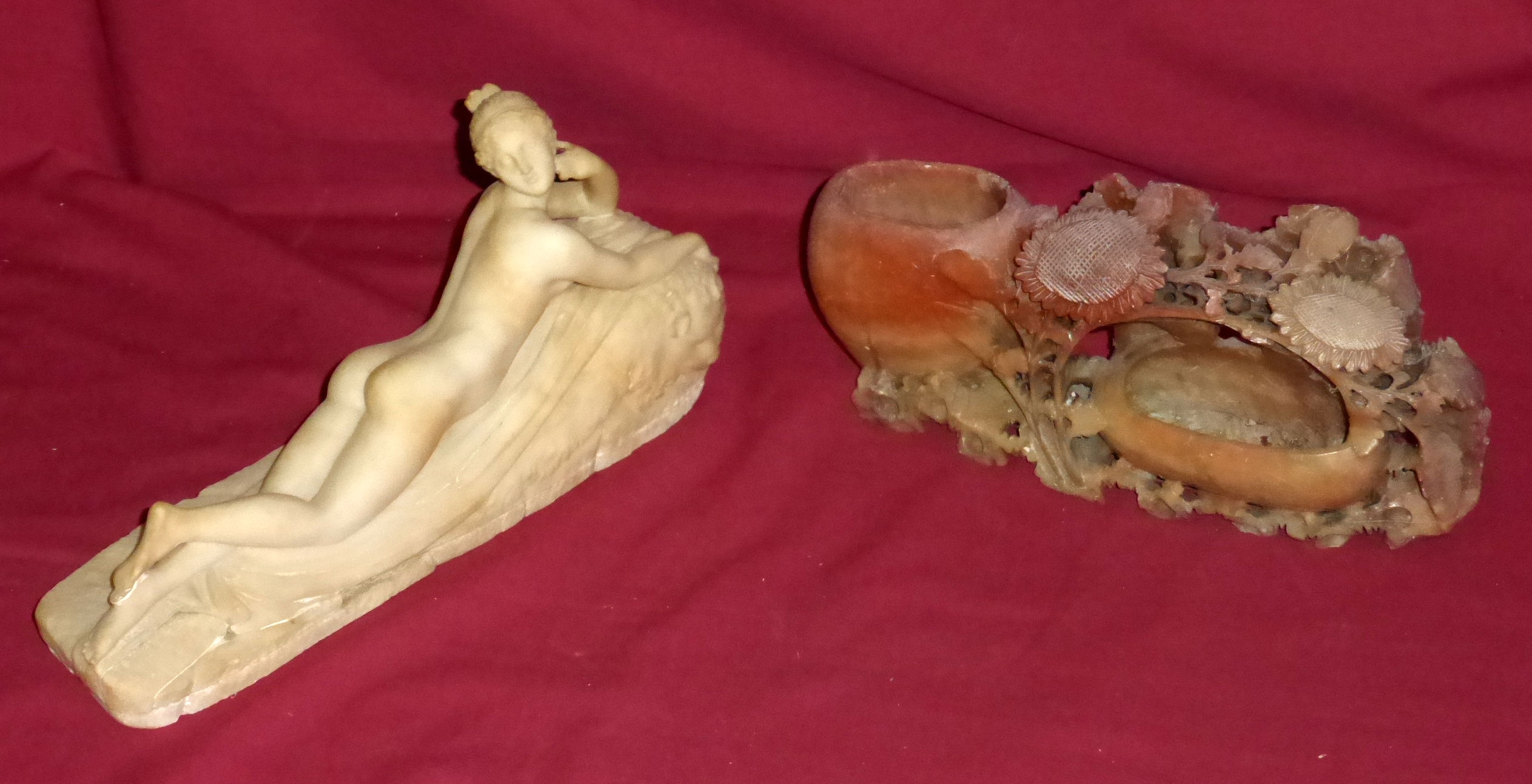 An alabaster Model of a reclining nude, 10 1/2" (27cms) long, and a carved soapstone Ornament.