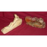 An alabaster Model of a reclining nude, 10 1/2" (27cms) long, and a carved soapstone Ornament.
