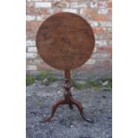 A 19th century mahogany circular tilt-top Occasional Table on a baluster turned column and triple