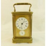 A late 19th/early 20th century Carriage Clock with circular white dial and subsidiary alarm dial,