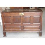 An 18th century oak Coffer with plain hinged lid, four panel front and stile supports, 4' 2" (