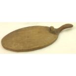 An early Thompson of Kilburn "Mouseman" oak oval Cheese Board with flattened handle, with a carved