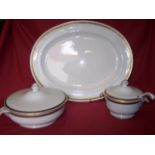 A Mintons Dinner Service decorated with a gilt key pattern border, comprising nine dinner plates,
