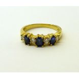 A gold sapphire and diamond, seven stone Ring, mark 18k.