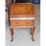 A small reproduction walnut Bureau with hinged fall and two drawers under, on shaped supports, 2' (