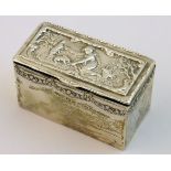 A silver Box of rectangular form, the hinged cover decorated with a scene of a girl feeding rabbits,