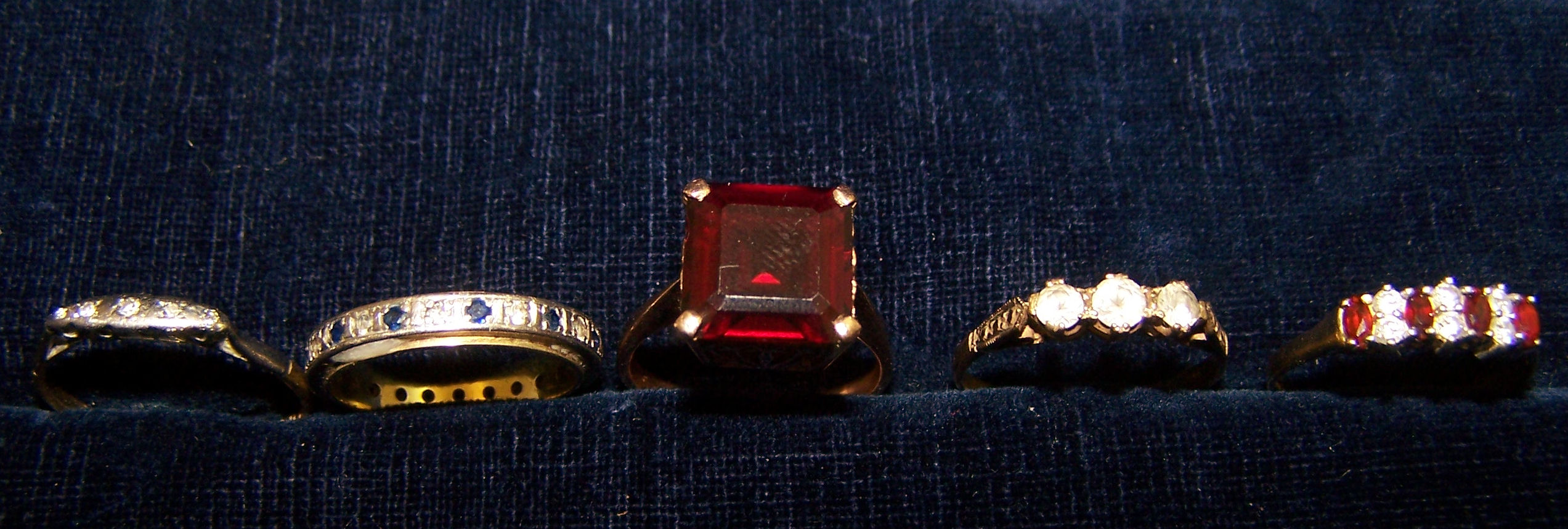An Eternity Ring, marked 14k, a 9ct. gold garnet set ring and three others.