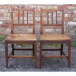 A pair of early 19th century elm Dining Chairs with rail backs, panel seats and square tapering