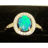 A silver Dress Ring set with a blue opal and cubic zirconia.