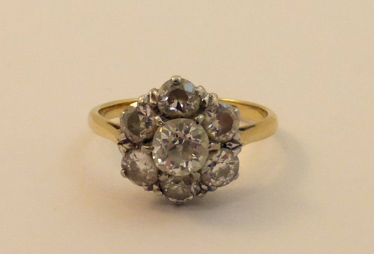 A gold seven stone diamond cluster Ring, marked 18ct plat.