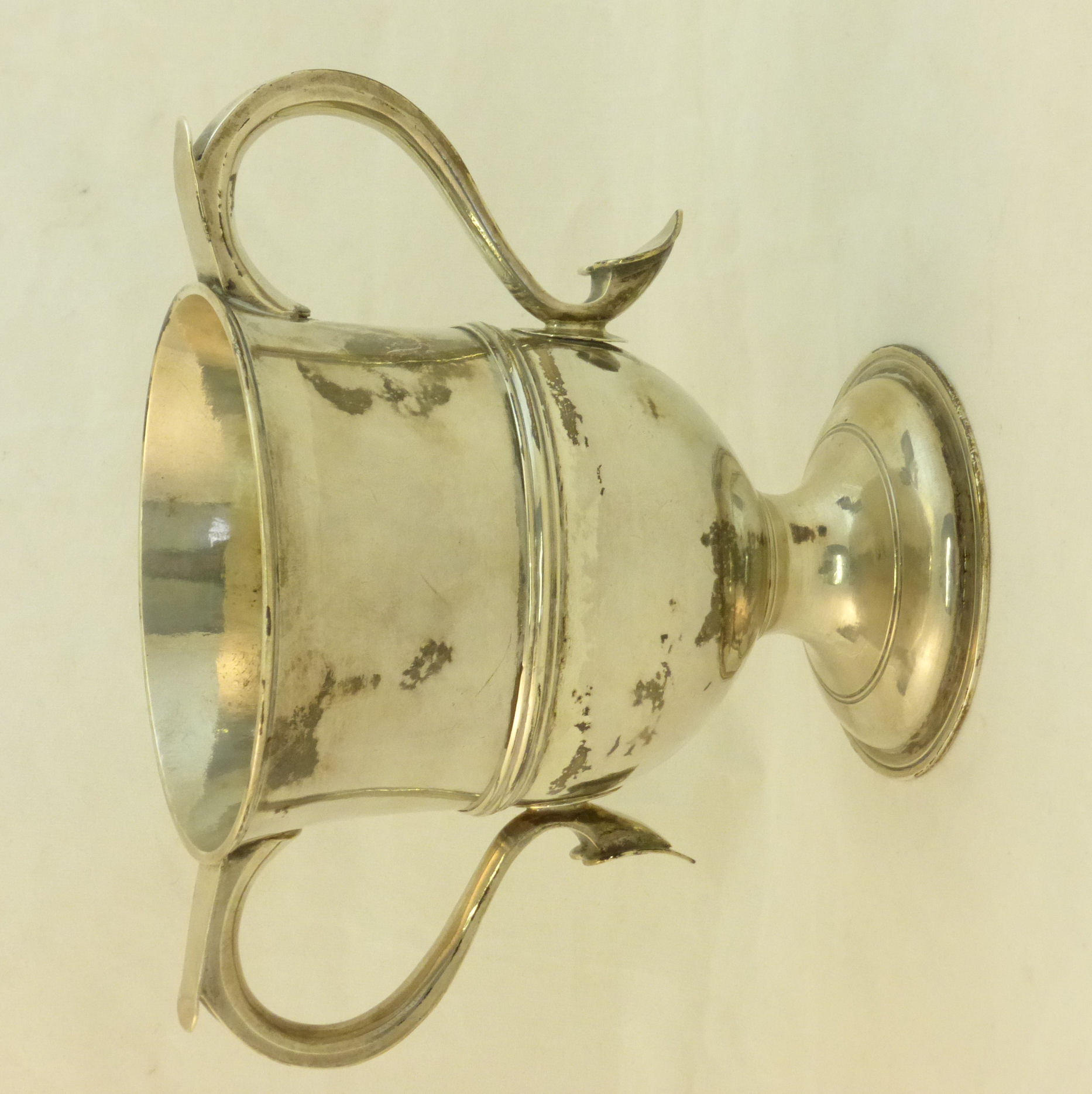 A George III silver two handled Cup with moulded girdle, on pedestal foot, engraved with initials,