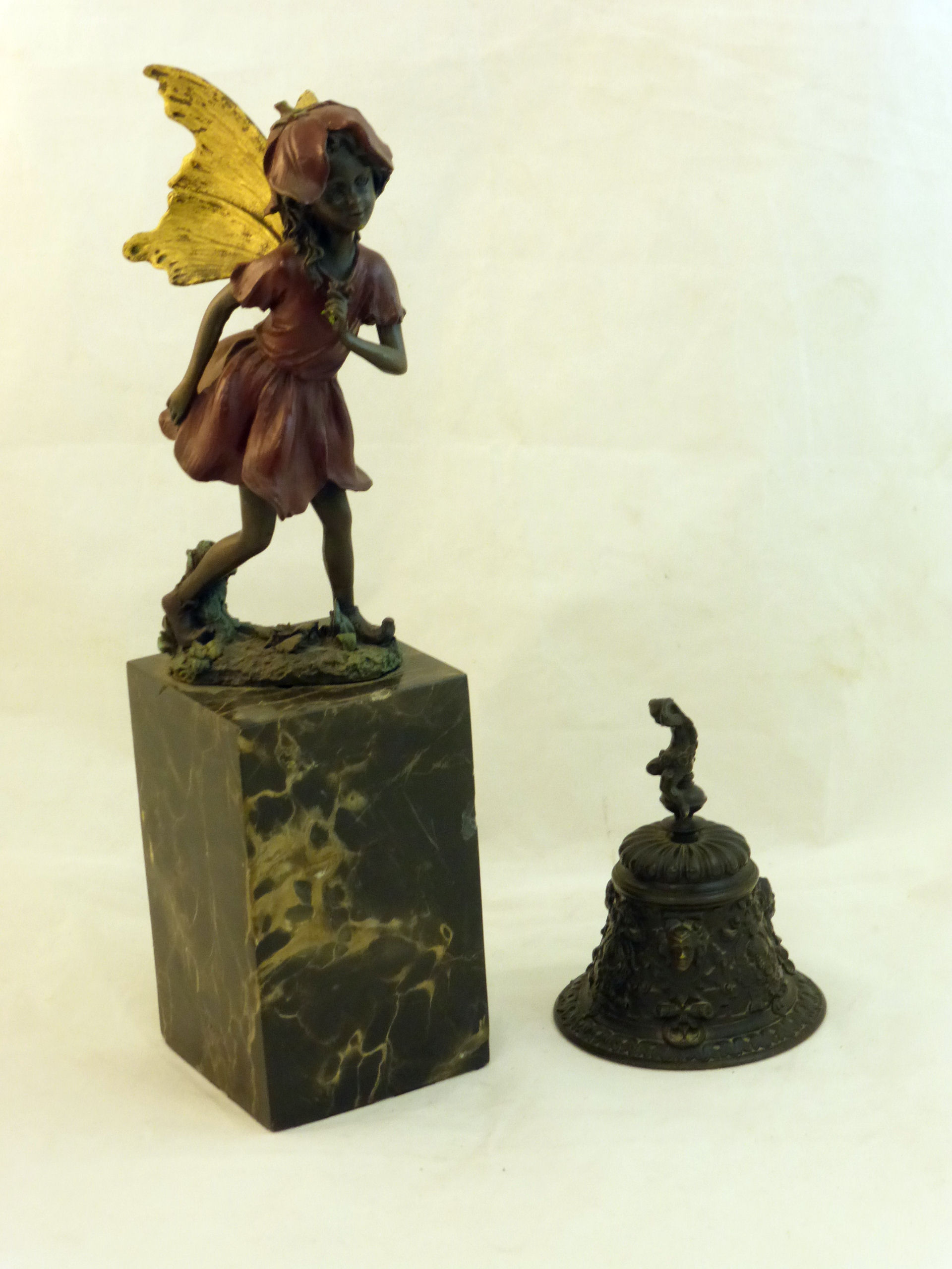 A bronzed Standing Figure of a Fairy with gilded wings on a marble plinth, 12" (31cms) high, and a