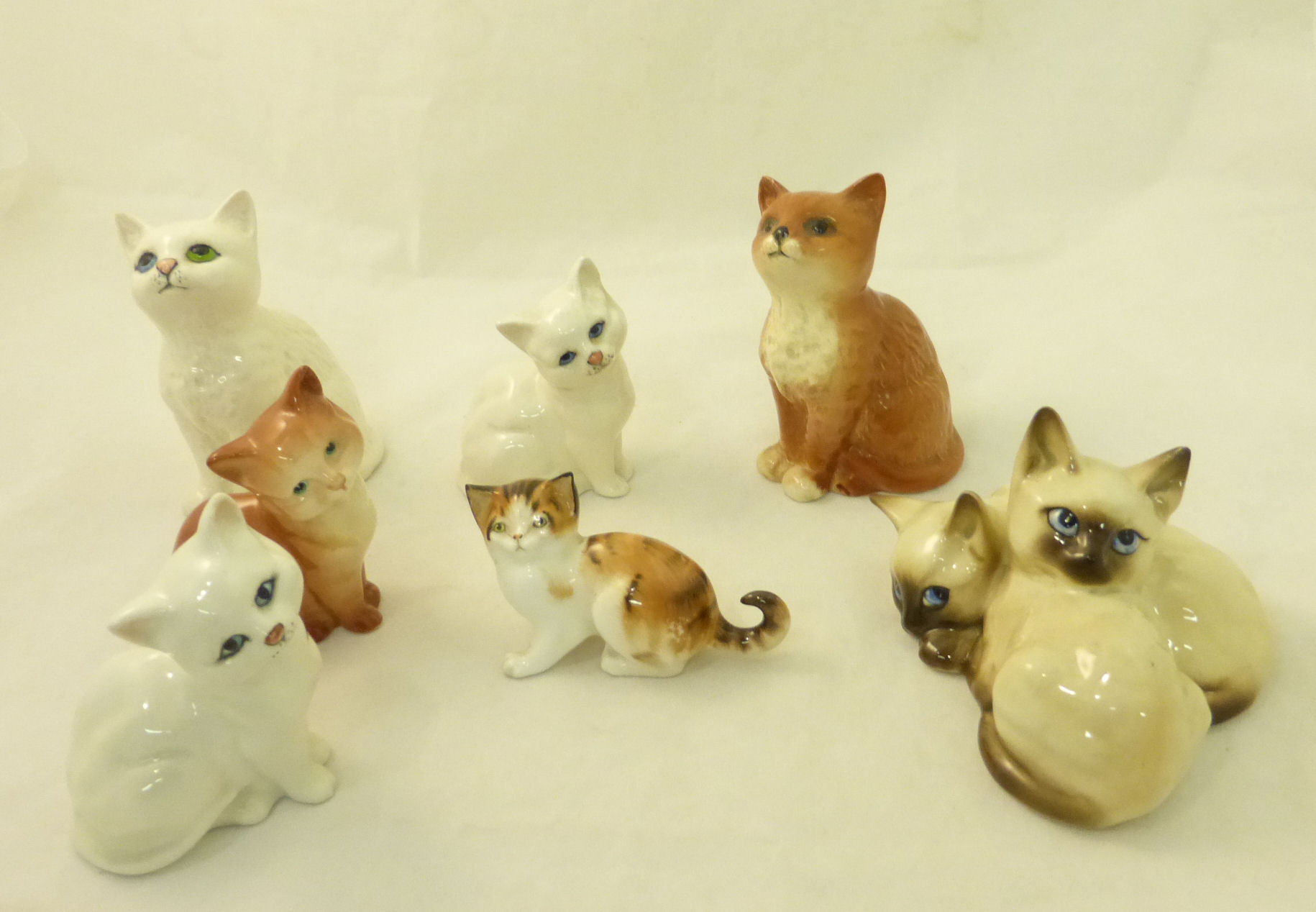 A pair of Beswick Siamese Kittens no. 1296, five other Beswick Kittens and a Royal Doulton Kitten.