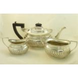 A silver three piece Teaset of oblong form with gadrooned edge and half body reeded decoration,