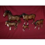 A Beswick Model of a brown cantering Shire Horse no. 975, a Beswick Model of a brown Mare, and