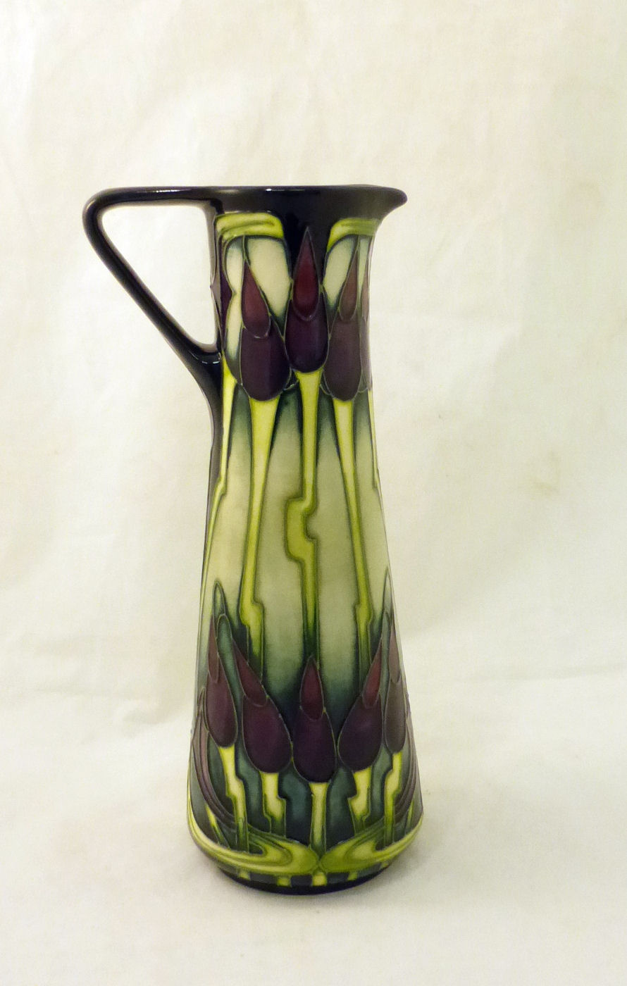 A Moorcroft Jug of tapering form decorated with the moonlit tulips pattern, 9 1/2" (24cms) high.