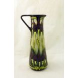 A Moorcroft Jug of tapering form decorated with the moonlit tulips pattern, 9 1/2" (24cms) high.