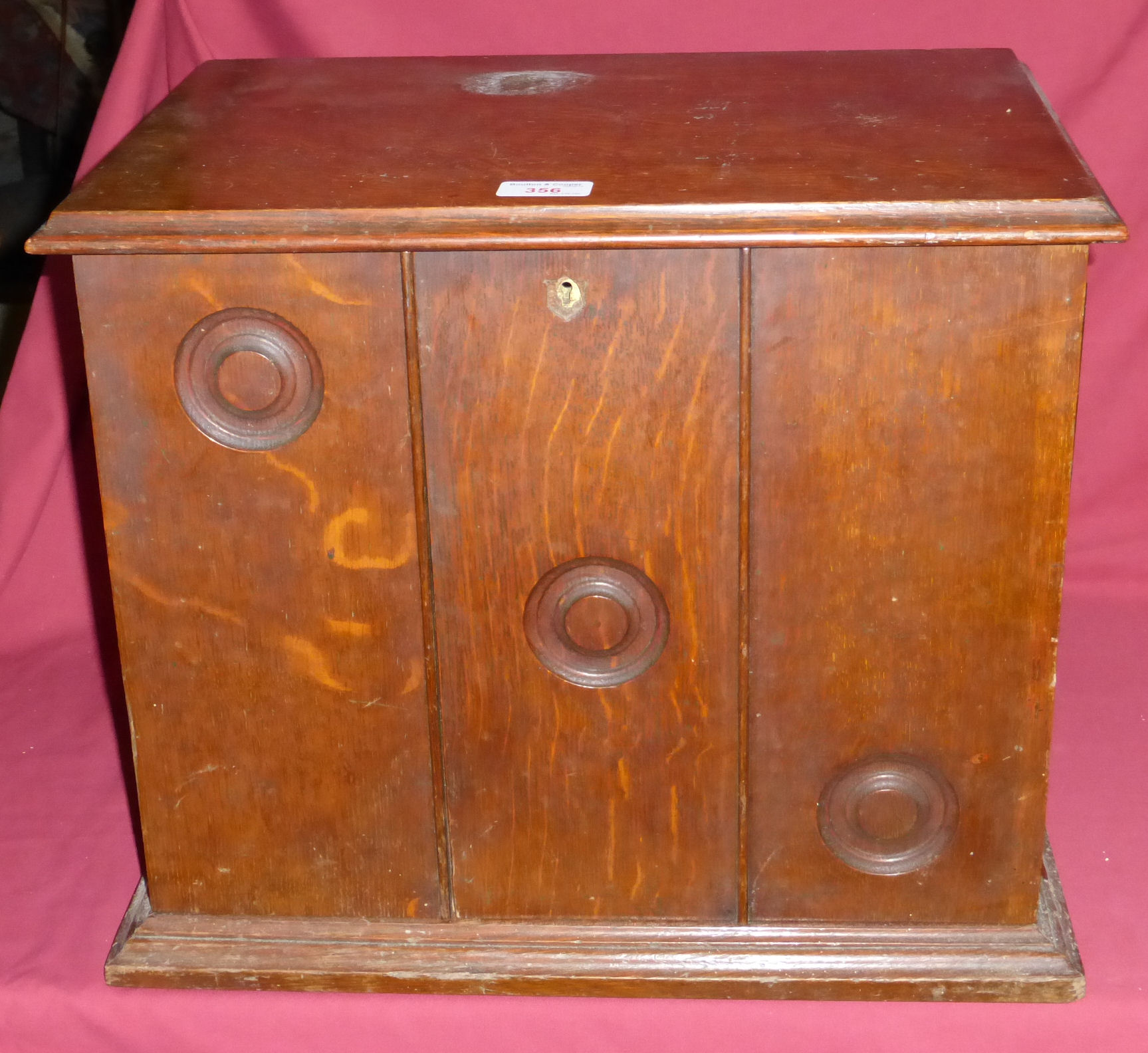 An Edwardian oak Stationery Casket with hinged lid and divided panelled front doors, the interior