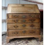 A George III mahogany Bureau, the interior fitted with small drawers, cupboard and pigeon holes,