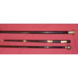 An ebonised Evening Cane with engraved silver top, a silver mounted ebonised Baton, and an