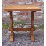 An adzed oak Side Table by Whittaker of Littlebeck, on panel end supports and with carved gnome