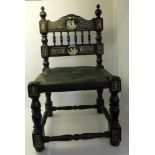 A late 19th century Italian ebonised low Chair inlaid in bone with classical figures, trailing