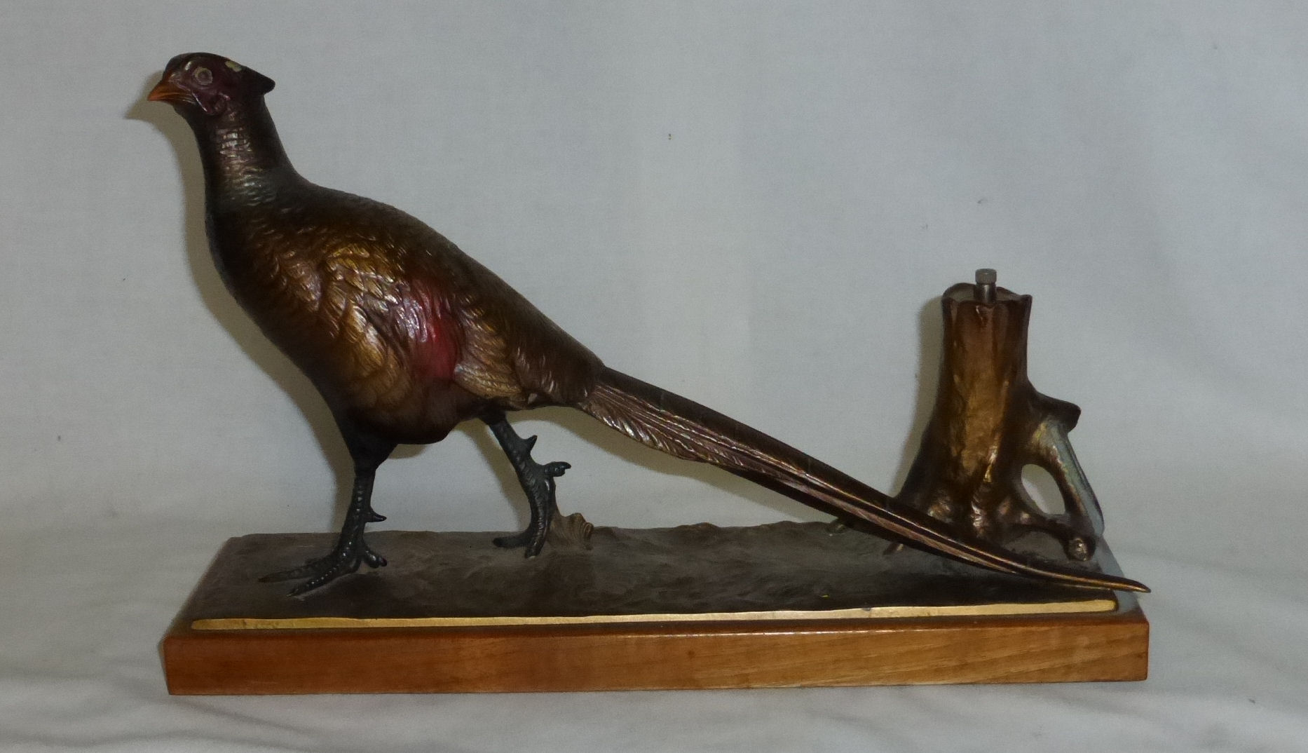 An early 20th century cold painted spelter Table Lighter in the form of a pheasant on an oblong