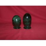 A green glass dumpy Paperweight inset with a vase of flowers, 3 1/2" (9cms) high, and another of
