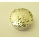 An Edwardian silver Box of circular form, the hinged cover depicting children playing, with import