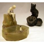 An onyx Ashtray surmounted by a nude ivory female figure and a crowned frog, 3" (7cms) high (
