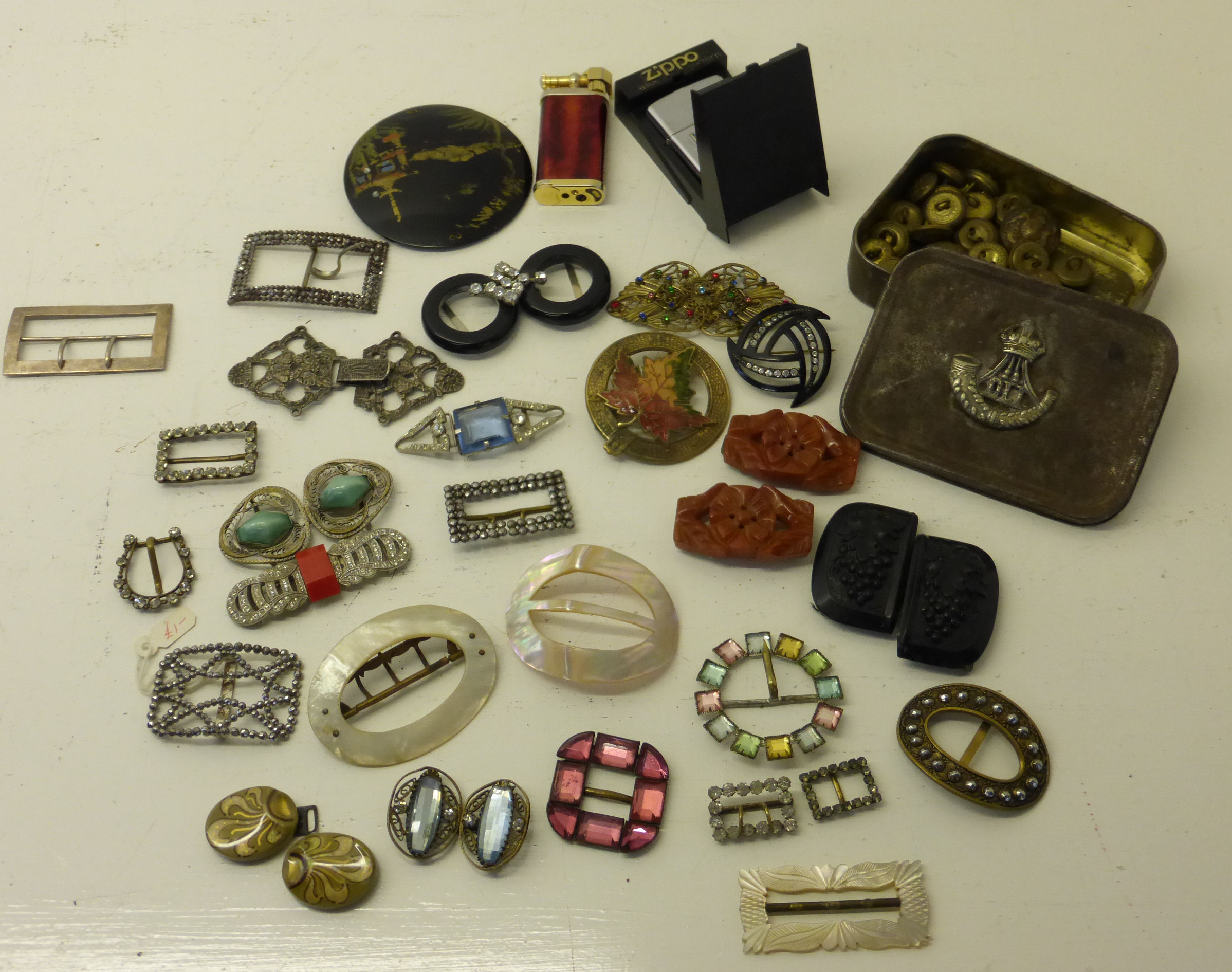 A Tin with the badge of the Durham Light Infantry and Contents of various military buttons, and a