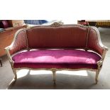 A continental design Sofa with painted and carved frame, upholstered seat and back, on shaped