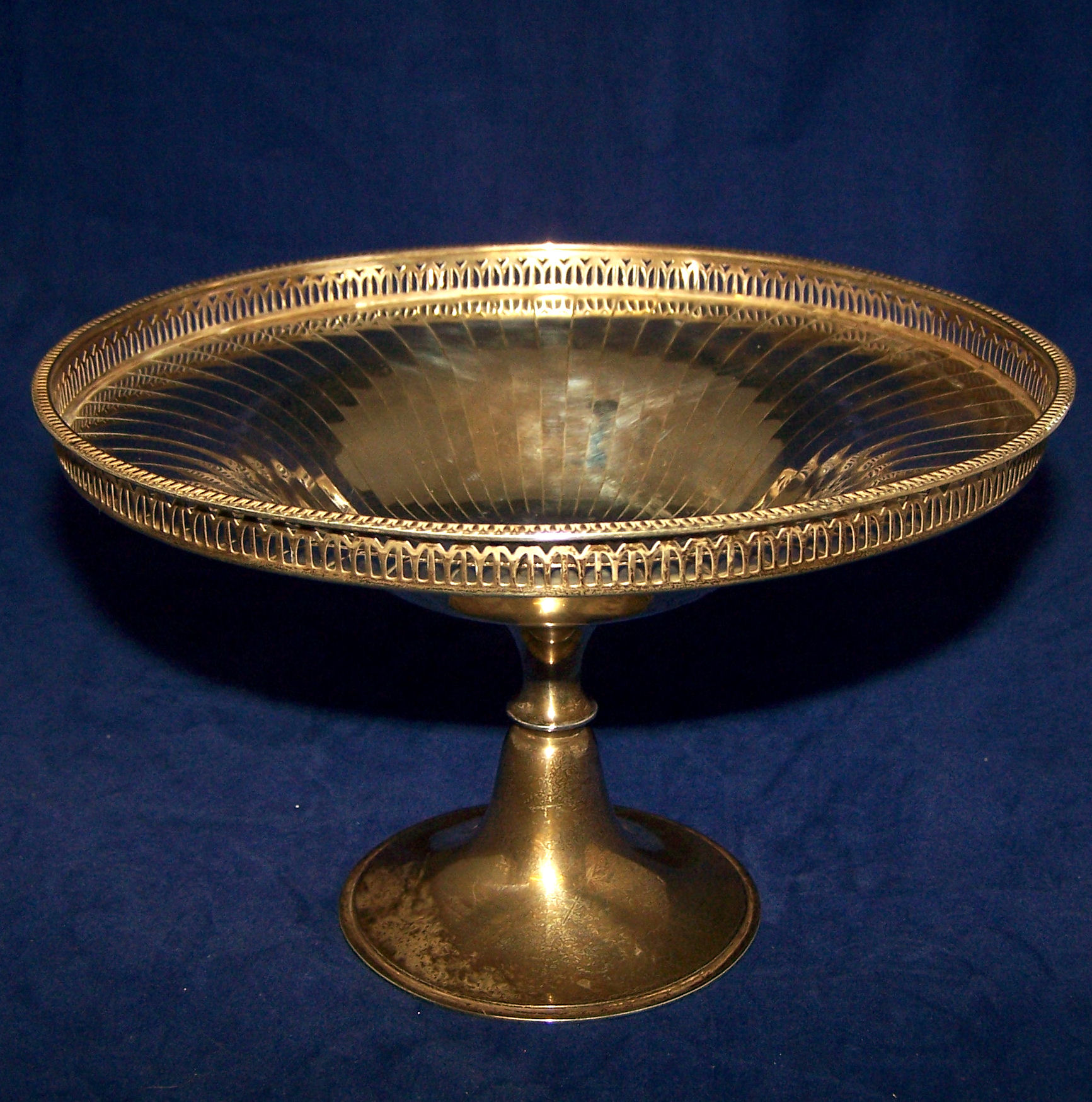 A silver circular Fruit Bowl with pierced raised border, fluted decoration and pedestal foot,