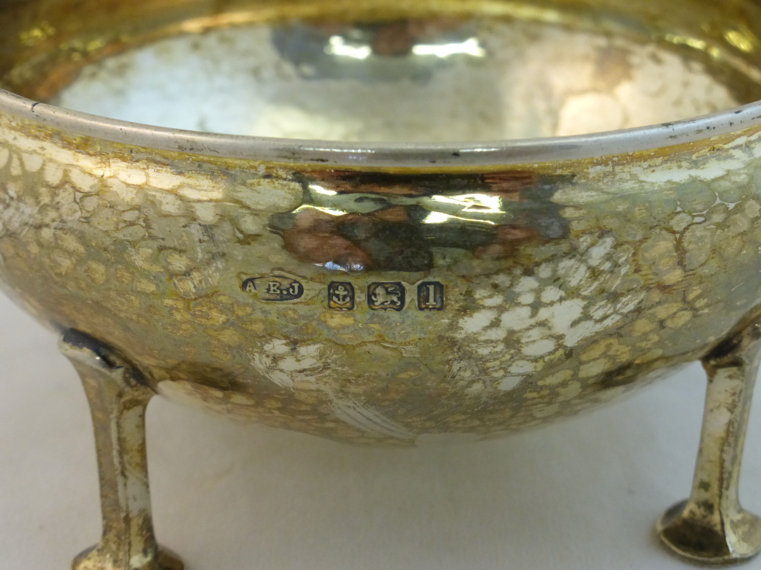 A silver Bowl of hammered circular form on four stylised legs, Birmingham 1910, maker: A E Jones, - Image 2 of 2
