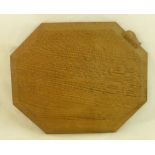 A Thompson of Kilburn "Mouseman" oak Bread Board of octagonal design and with carved mouse