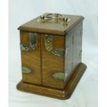 An Edwardian oak Smoker's Cabinet with hinged lid and divided front panelled door, the interior