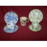 An early 19th century Rockingham trio of Cup, Saucer and Plate, printed with Chinese figures,