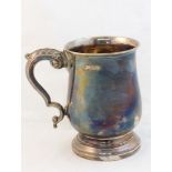 A silver Mug with scroll handle, on collet foot, Sheffield 1964, maker: E H Parkin & Co, 9oz.