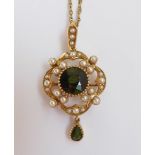 An Edwardian gold Pendant/Brooch, the central circular mixed cut green tourmaline within a lobed