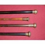 An ebonised Evening Cane with silver top and three other silver mounted Canes.
