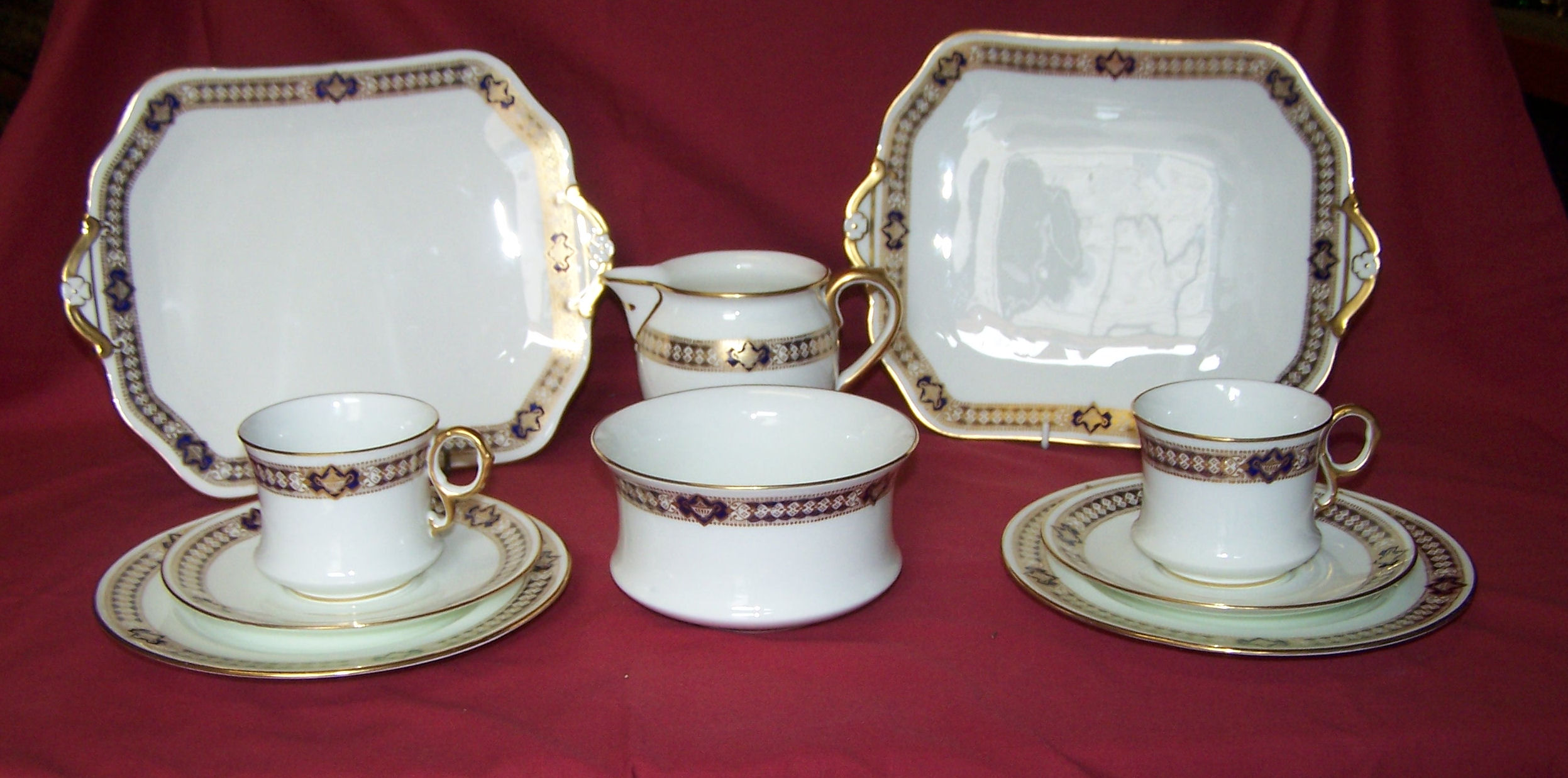 A Cauldon China Teaset decorated with border pattern in blue and gilt, comprising twelve cups and