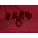 Twenty-one pink bowled Wine Glasses with clear glass stems, and a cranberry glass Jug.