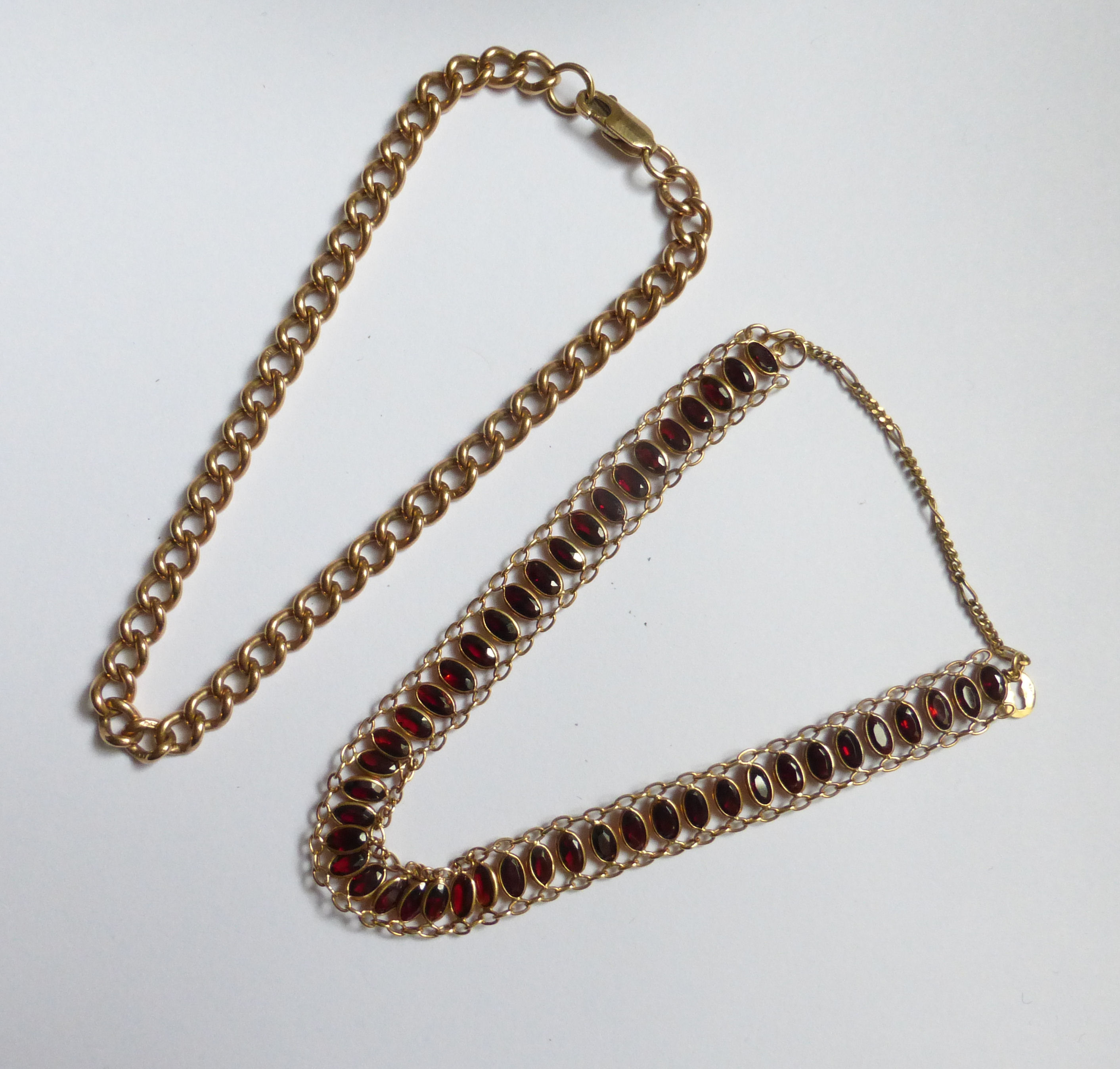 A 9ct. gold garnet set Bracelet and 9ct. gold curb link bracelet.