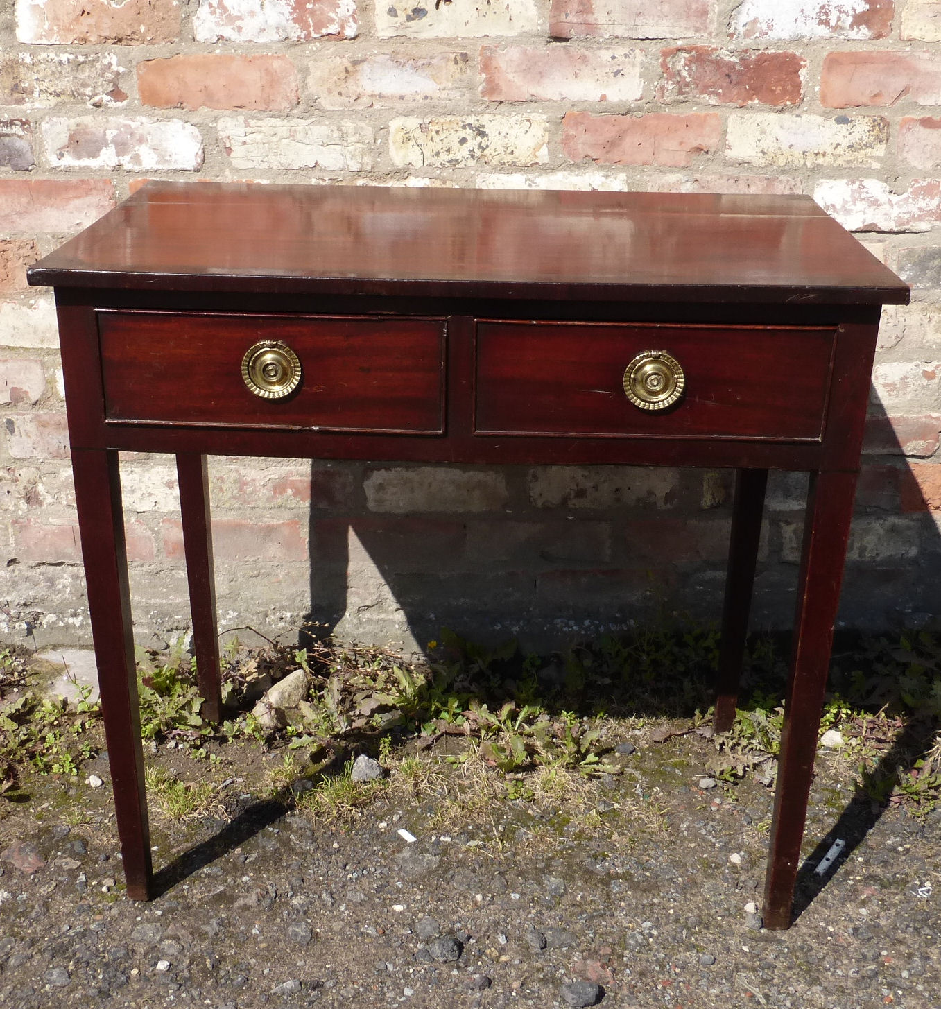 An early 19th century mahogany Side Table with cross banded top, two frieze drawers and square