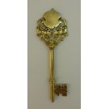 A silver gilt Presentation Key, the finial with blank shield and scrolling flower decoration,