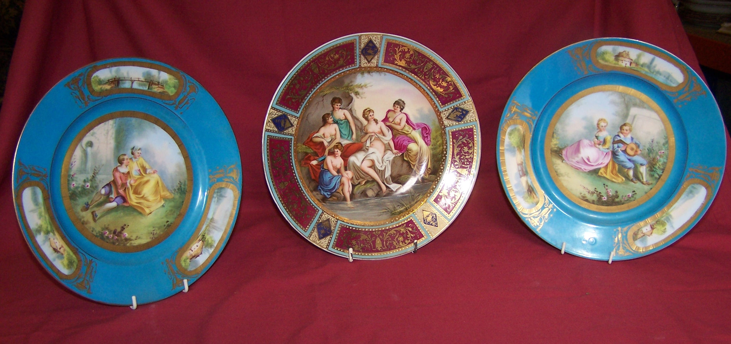 A pair of 19th century French porcelain Plates decorated with figures in a country garden within a