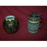 A Doulton Lambeth Lidded Jug with pewter cover and decorated with stylised rosette design, and a