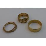 A 9ct gold Buckle Ring with floral decoration, a 9ct gold Wedding Ring, and a 9ct gold three